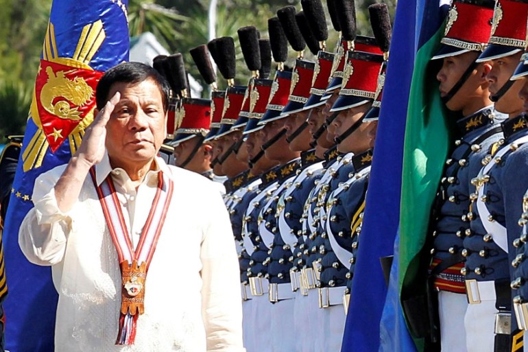 Philippine President Rodrigo Duterte salutes during arrival honours at the Philippine Military Academy in Baguio