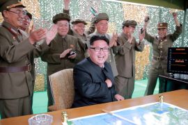 FILE PHOTO: North Korean leader Kim Jong Un reacts during a test launch of ground-to-ground medium long-range ballistic rocket Hwasong-10