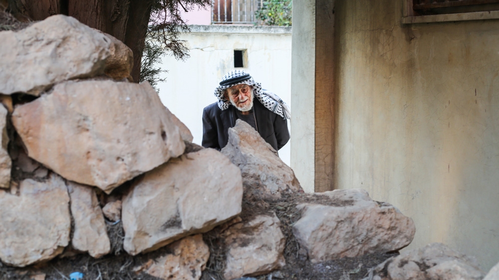 Lahham visits the ruins of the homes he built before Dheisheh refugee camp was established [Soud Hefawi/Al Jazeera]