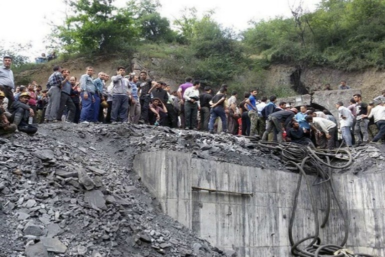 People gather at the site of an explosion in a coal mine in Golestan Province