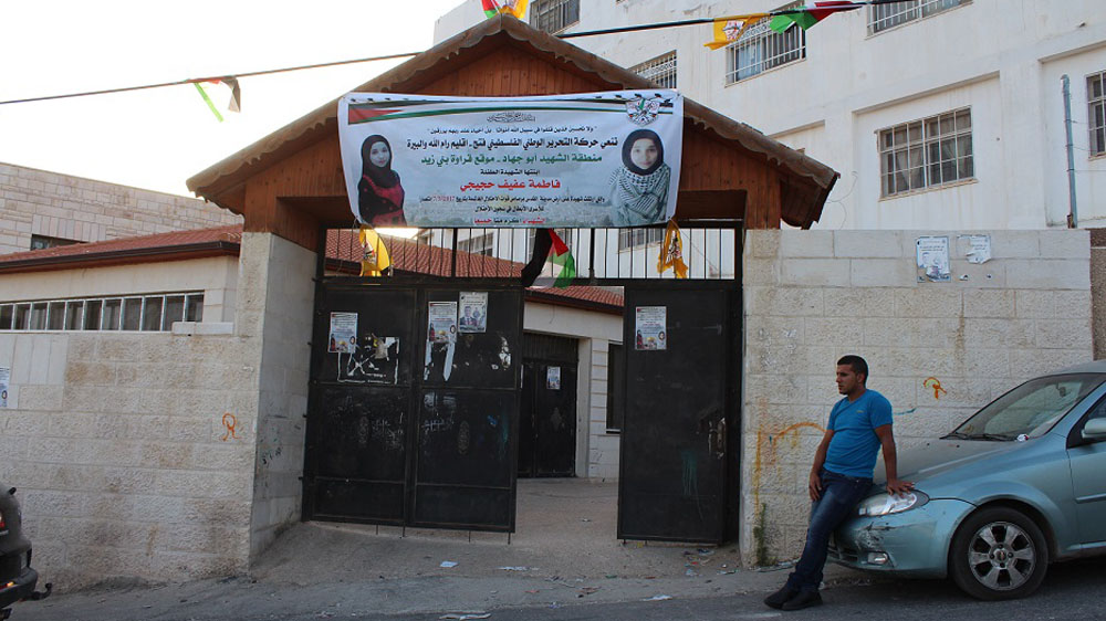 Men gathered inside a community hall in Qarawat Bani Zeid village to offer condolences to the family of Fatima Hjeiji [Nigel Wilson/Al Jazeera]