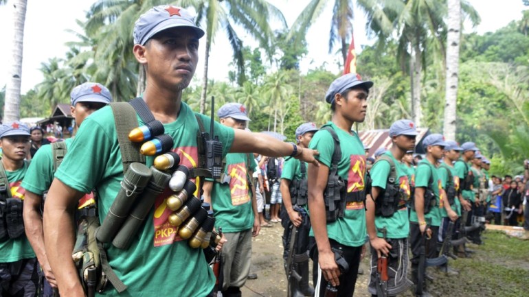 Members of the New People''s Army rebels stand in attention during the 46th anniversary celebration of the Communist Party of the Philippines at a Marihatag town, Surigao del sur