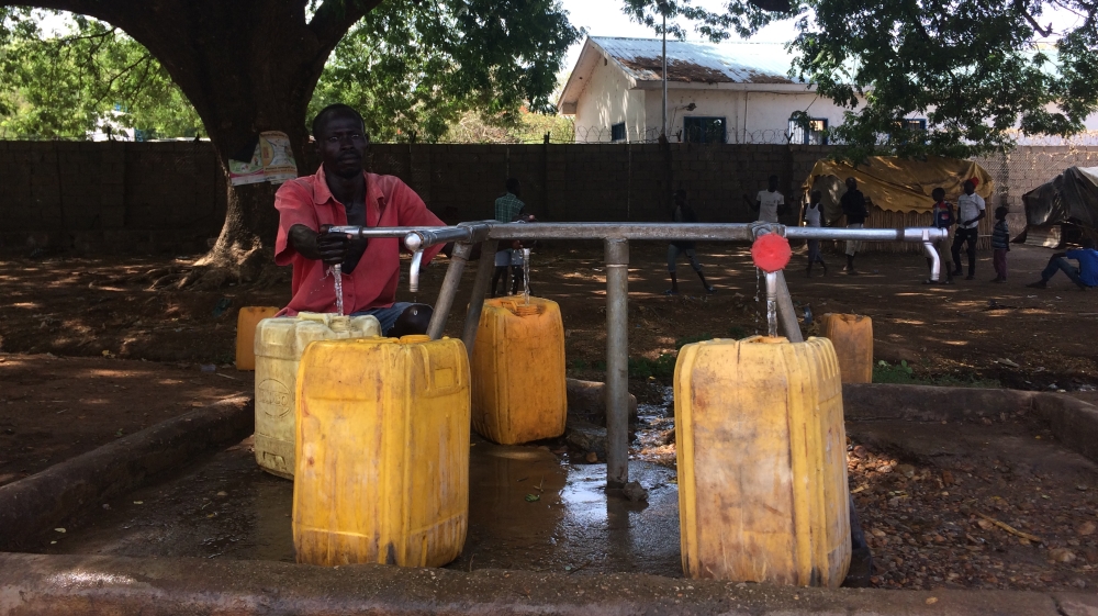 
A resident of Hai Gabat fills up jerrycans at one of Juba's two UNICEF-installed water points, which provides about 50,000 litres of safe, clean water every day [Sofia Barbarani/Al Jazeera]
