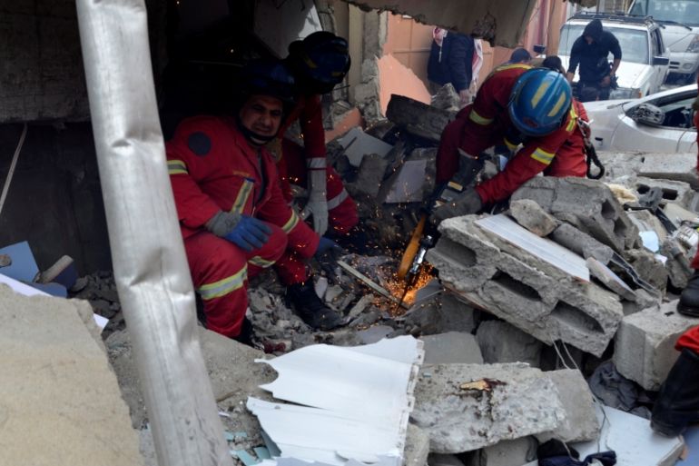 Firefighters search for the bodies of civilians who were killed after an air strike against Islamic State triggered a massive explosion in Mosul