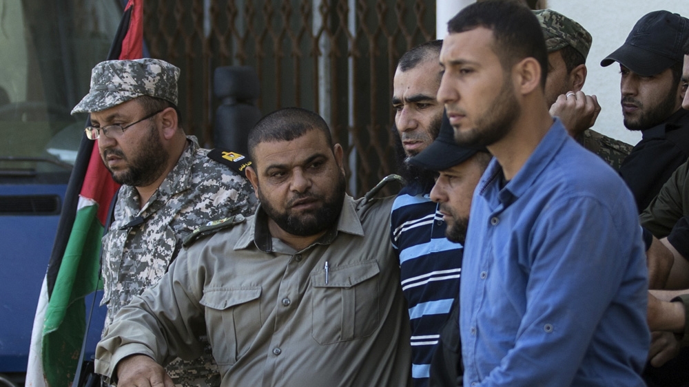Ashraf Abu Leila, centre, is considered the main suspect behind the killing of Faqha [Mahmud Hams/AFP]