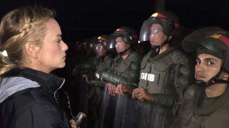 Lilian Tintori, wife of jailed Venezuelan opposition leader Leopoldo Lopez, stands in front of Venezuelan National Guards outside the military prison of Ramo Verde in Los Teques