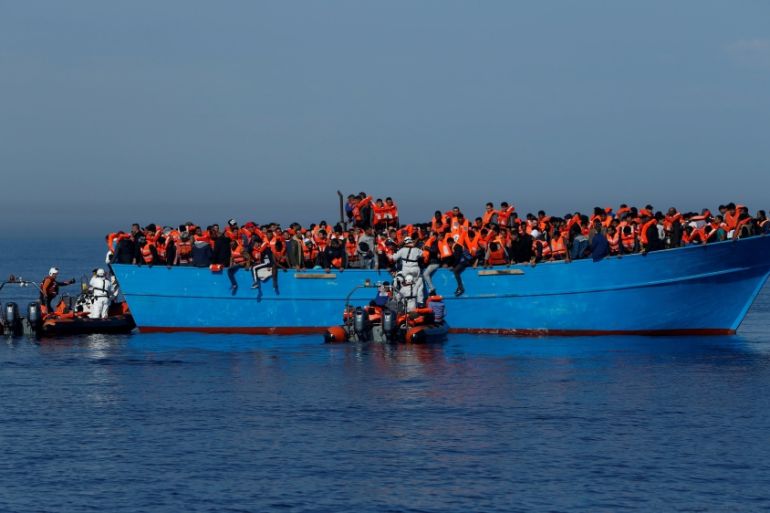 FILE PHOTO: Migrants on a wooden boat are rescued by the Malta-based NGO Migrant Offshore Aid Station (MOAS) in the central Mediterranean