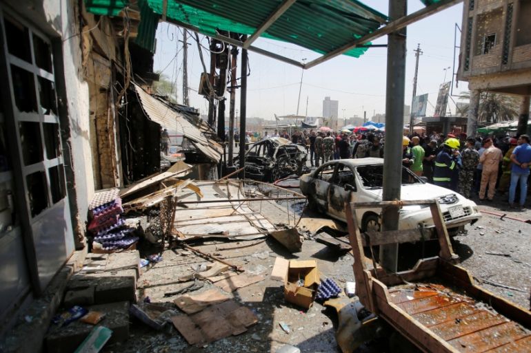 Damaged shops are seen at the site of car bomb attack near a government office in Karkh district in Baghdad