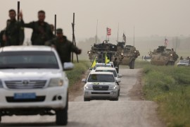 Kurdish fighters from the People''s Protection Units (YPG) head a convoy of U.S military vehicles in the town of Darbasiya next to the Turkish border