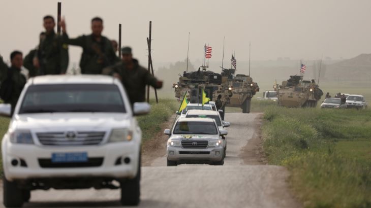 Kurdish fighters from the People''s Protection Units (YPG) head a convoy of U.S military vehicles in the town of Darbasiya next to the Turkish border