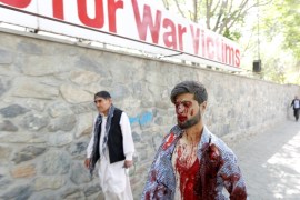 An injured man arrives at a hospital after a blast in Kabul, Afghanistan