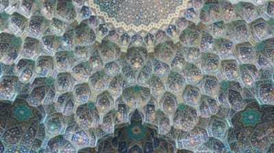 Turquoise and sapphire, the trademark colours of Isfahan, are woven throughout this intricate mosque ceiling design [Wojtek Arciszewski/Al Jazeera]