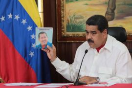 Maduro holds an image of Chavez in Caracas
