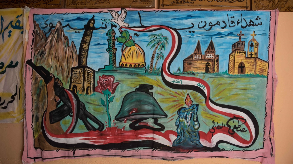 Outside Taie's house, a mural depicts painted palm trees and Iraqi flags fluttering over a mosque and a church [Campbell MacDiarmid/Al Jazeera]