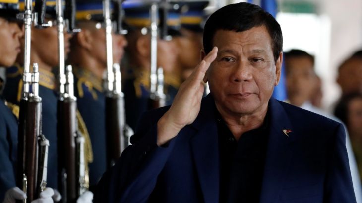 Philippine President Rodrigo Duterte salutes the honor guards upon arrival from Russia at the Ninoy Aquino International airport in Paranaque, Metro Manila