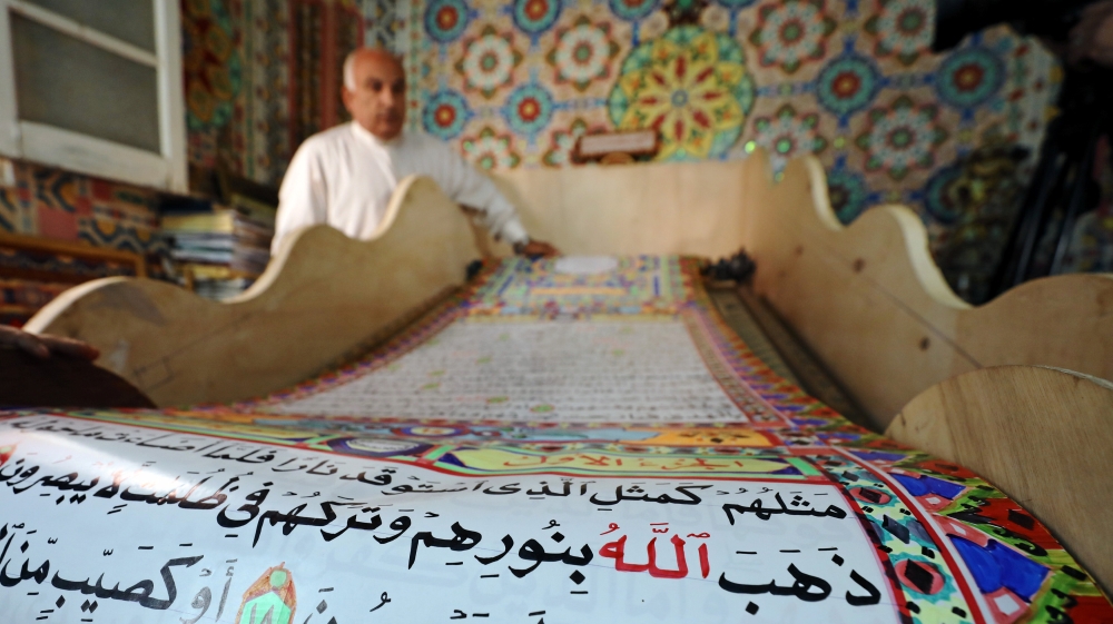Mohammed spent three years reproducing the Quran on a huge paper scroll [Mohamed Abd El Ghany/Reuters]