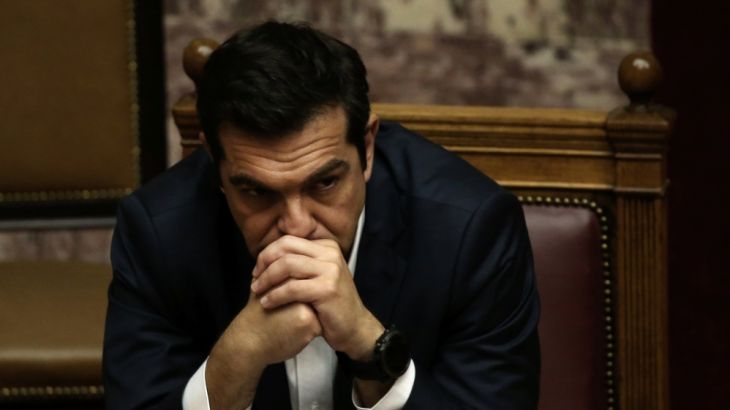 Greek PM Tsipras attends a parliamentary session before a vote on the latest round of austerity Greece has agreed with its lenders, in Athens