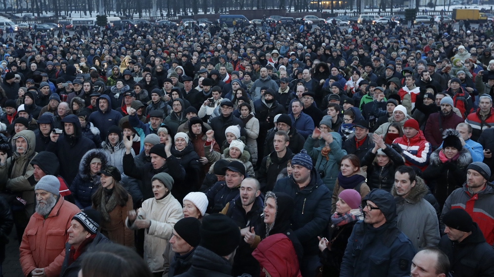 People gather for a protest rally in downtown Minsk, Belarus. Several thousand demonstrators protested against a law that imposes a tax on those not in full-time employment [Sergei Grits/AP] 
