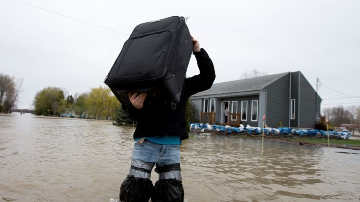 A resident removes belongings from his home in a flooded residential neighbourhood in Rigaud, Quebec