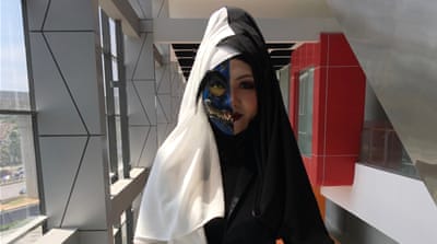 A non-Muslim woman attends the hijab cosplayer event to show her support for it. [Preeti Jha/Al Jazeera]