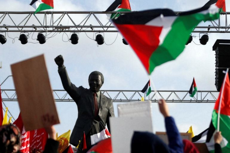 The Nelson Mandela statue is seen as demonstrators take part in a rally in support of Palestinian prisoners on hunger strike in Israeli jails, in the West Bank city of Ramallah