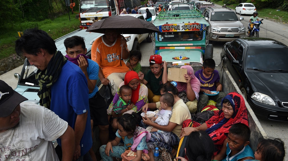 Residents flee Marawi City on the southern island of Mindanao [Ted Aljibe/AFP]