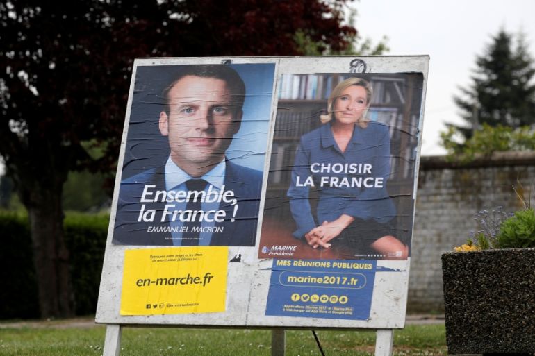 Official posters of the candidates for the 2017 French presidential election, Emmanuel Macron and Marine Le Pen are displayed in Sorrus