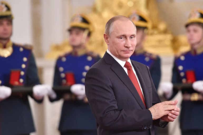 Russian President Putin applauds during the State Prize awards ceremony marking the Day of Russia at the Kremlin in Moscow