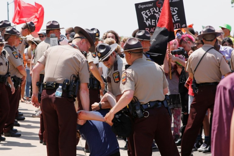 Anti-sharia protesters scuffle with counter demonstrators and members of the Minnesota State Patrol at the state capitol in St. Paul, Minnesota