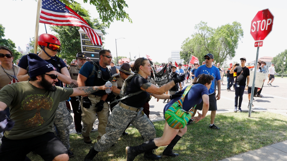 Clashes between anti-Muslim march participants and anti-fascists such as these in St Paul happened in many other cities [Reuters]