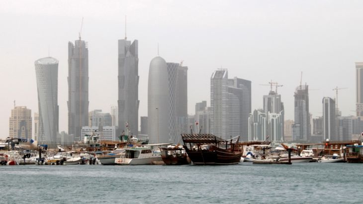 FILE PHOTO: Traditional fishing Dhows are seen in port near modern glass and steel buildings on the Doha skyline