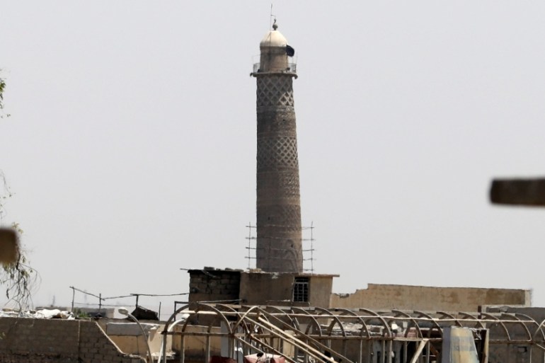 An Islamic State militants flag is seen on top of the minaret of al-Nuri mosque in the Old City in western Mosul