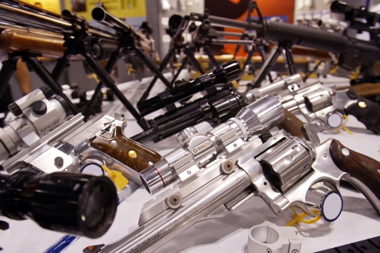 FILE PHOTO - Various assault rifles and handguns sit on display at the 132nd Annual National Rifle Association Meeting in Orlando