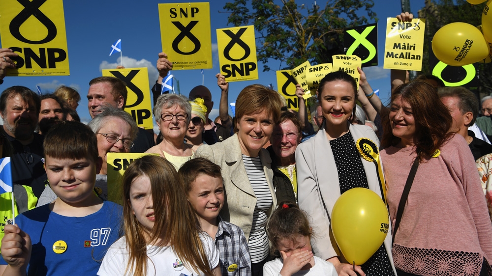 SNP leader Nicola Sturgeon with supporters and local SNP candidate for Dumfriesshire, Clydesdale and Tweeddale Mairi McAllan, second from right, while campaigning for the General Election on June 3, 2017 in Biggar, Scotland [Jeff J Mitchell/Getty Images] 