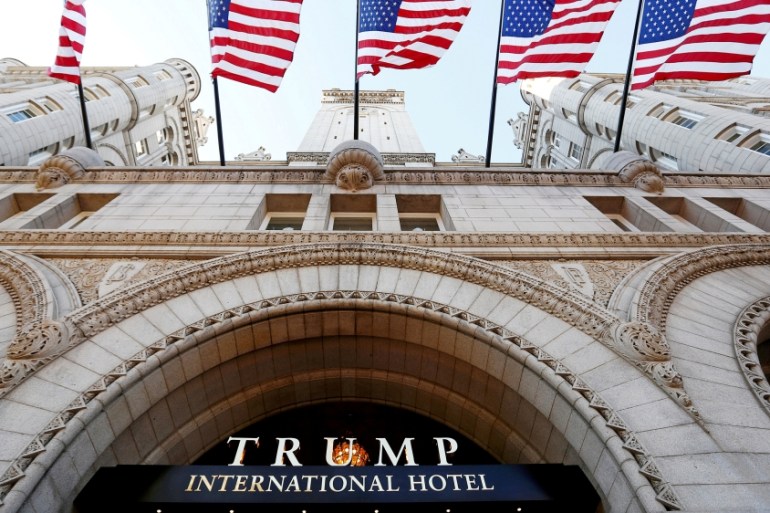 FILE PHOTO - Flags fly above the entrance to the new Trump International Hotel on its opening day in Washington
