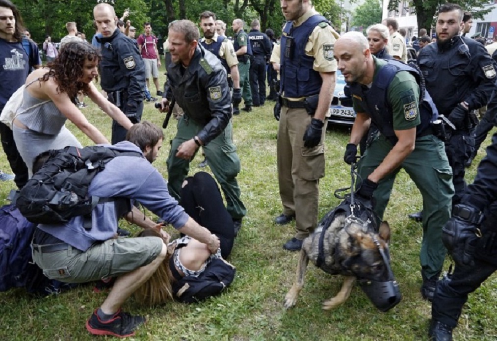 Germans confront police in Nuremberg as they try to detain and deport a young Afghan man [Michael Matejka/dpa/AFP]