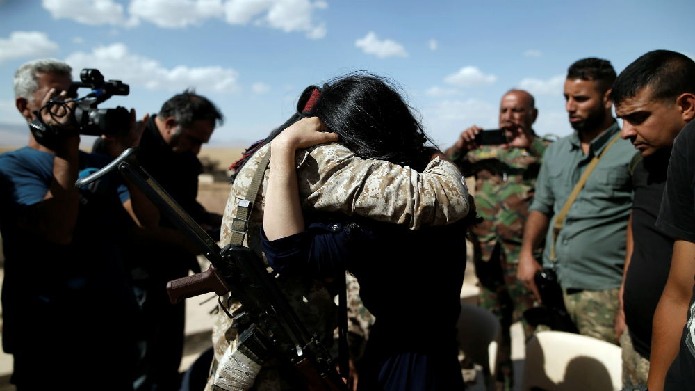 Nadia Murad hugs her brother Saeed as she visits her village for the first time after being captured and sold as a slave by ISIL [Alkis Konstantinidis/Reuters]