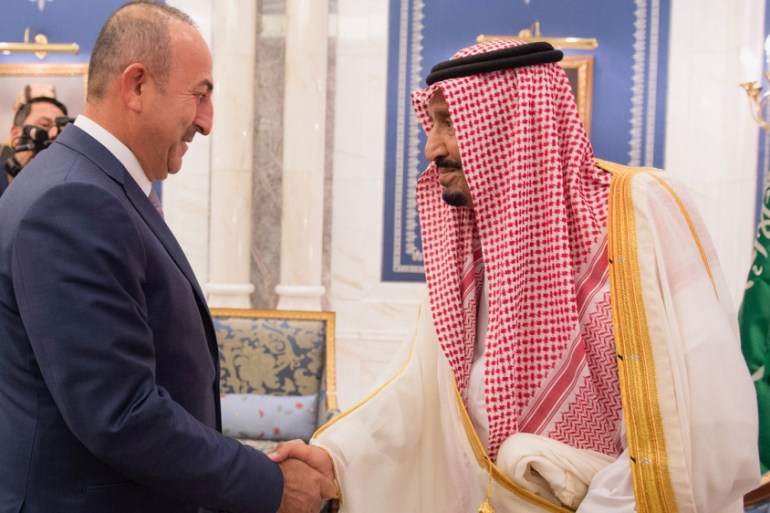 Saudi Arabia''s King Salman bin Abdulaziz Al Saud shakes hands with Turkish Foreign Minister Mevlut Cavusoglu in Jeddah