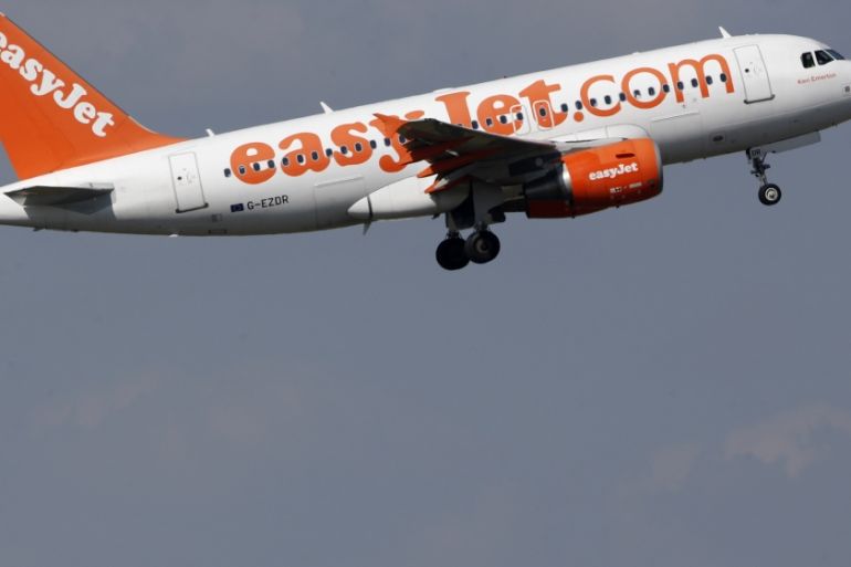 An easyJet aircraft takes-off past Air France plane tails at the Charles-de-Gaulle airport