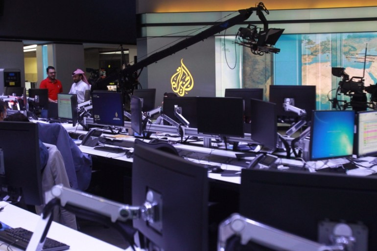 Staff work inside Al Jazeera Media Network HQ in Doha