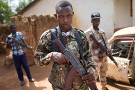 Armed fighters belonging to the 3R armed militia stands guard while their leader General Sadiki is talking to the media in the town of Koui, Central African Republic