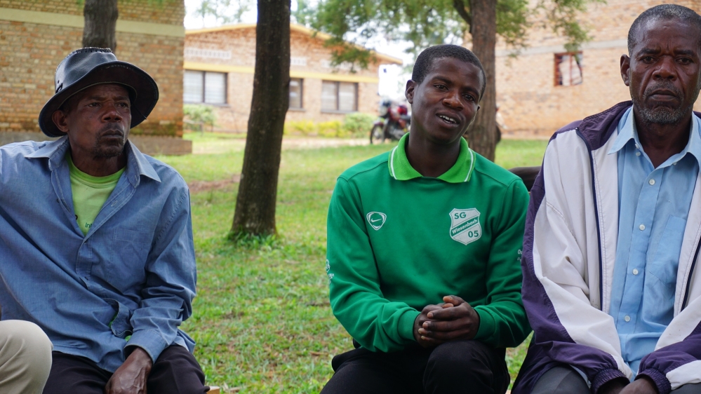 Evariste Shumbushuya, right, says contested narratives are the source of conflict between children in classrooms, which he hopes to ease through cooperative projects [Valerie Hopkins/Al Jazeera]