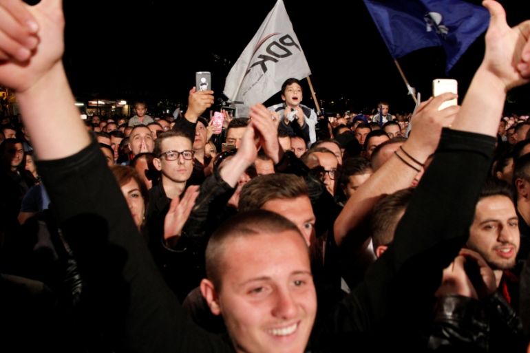 Supporters of the coalition of the former KKLA commanders AAK, PDK and NISMA celebrate after first results of the Parliamentary elections in Pristina, Kosovo