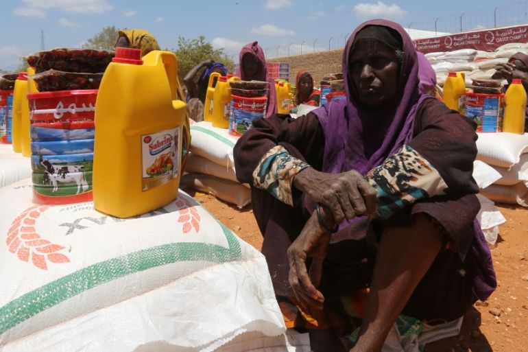 An internally displaced Somali woman receives relief food at a distribution centre organized by a Qatar charity