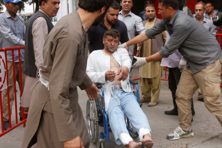 An injured man leaves a hospital after he received treatment, after a blast in Kabul