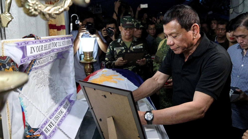 Philippine President Rodrigo Duterte visits the wake of a soldier killed by friendly fire [Presidential Palace/Handout/Reuters]