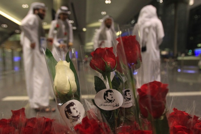 Flowers and pictures of Qatar Emir Sheikh Tamim Bin Hamad Al-Thani are pictured during the arrival of Kuwaiti and Omani citizen at Hamad international airport in Doha