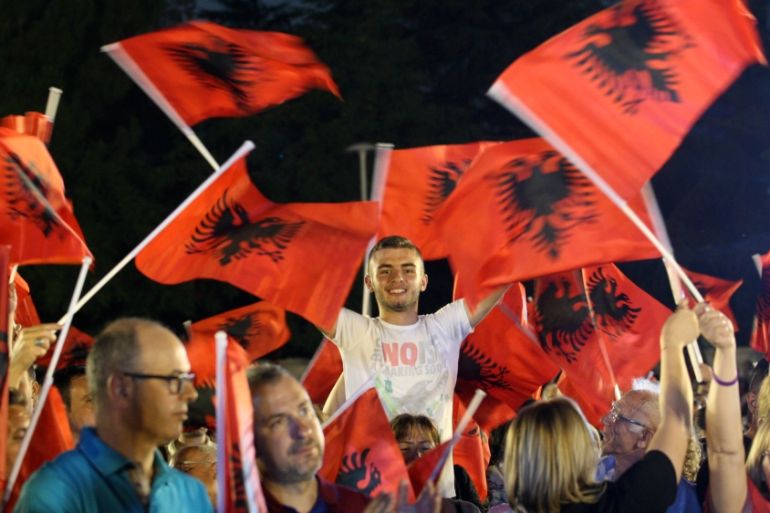 Supporters of Socialist Party wave their flags during a pre-election rally in Tirana, Albania