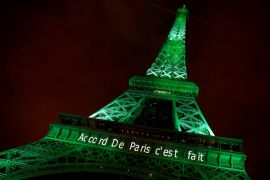 FILE PHOTO: The Eiffel tower is illuminated in green with the words "Paris Agreement is Done", to celebrate the Paris U.N. COP21 Climate Change agreement in Paris