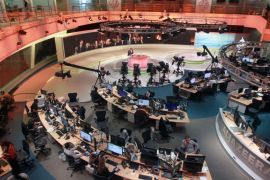 Staff work inside the Al Jazeera Network HQ in Doha